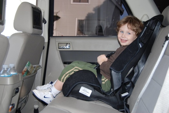 Kid in a limo with booster seat 